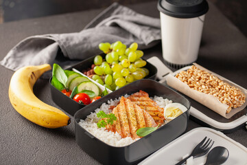 Healthy lunch at office workplace. Takeaway lunch boxes with nutrition food - fish, vegetables and fruits at working desk