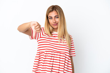 Blonde Uruguayan girl isolated on white background showing thumb down with negative expression