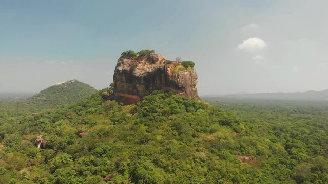 Aerial view of Sigiriya Lion's Rock, a rock fortress located in the northern Matale District, Dambulla, Sri Lanka. Drone footage 4K