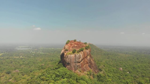Aerial view of Sigiriya Lion's Rock, a rock fortress located in the northern Matale District, Dambulla, Sri Lanka. Drone footage 4K