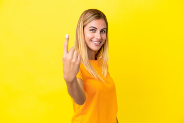Blonde Uruguayan girl isolated on yellow background doing coming gesture