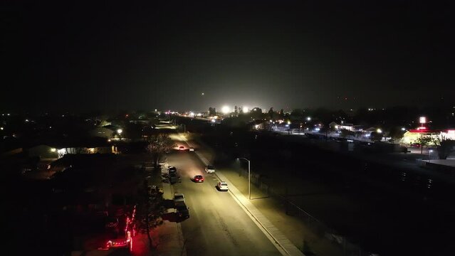 Nighttime street traffic in Tehachapi City, California - static drone view