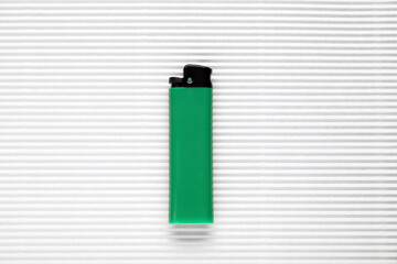 Stylish small pocket lighter on white corrugated fiberboard, top view