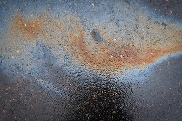 Fototapeta na wymiar Image of an oil stain on the asphalt of a wet road.