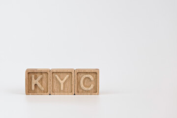 KYC know your customer guidelines in financial services theme. wooden cubes with the acronym KYC,...