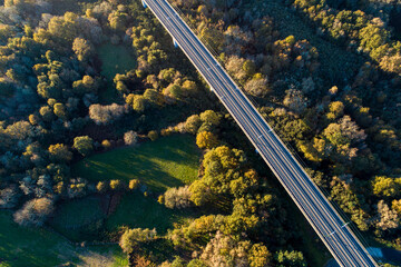 drone aerial view of a high speed rail line in a viaduct at sunset