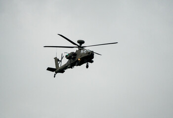 Fototapeta na wymiar British army AH-64E Boeing Apache Attack helicopter (ZM722 ArmyAir606) on landing approach, autumn sky