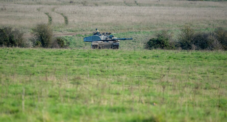 commander directing action on a British army FV4034 Challenger 2 ii main battle tank on a military exercise, Wiltshire UK