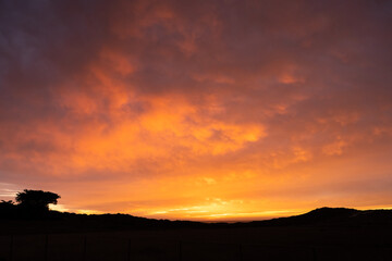 Orange and Pink Sunset Colors Over California Hillside