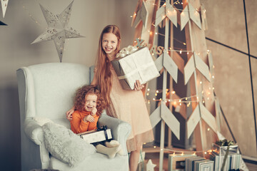 two little girls with Christmas presents on Christmas eve