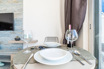 Red wine tasting at home: wine bottle on a table in the living room