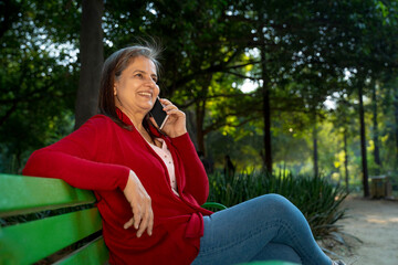 Indian woman talking on smartphone at park