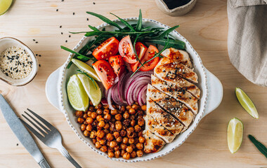 Spicy Chicken Nourish Bowl. A filling and nutritious warm salad with grilled chicken, spicy chickpeas, tomato and arugula