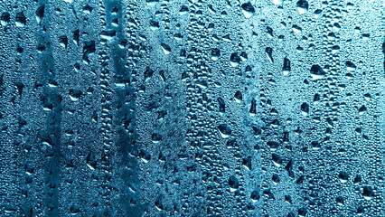 Condensation on window glass in frosty winter weather. Background in the form of small drops on the...