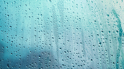 Condensation on window glass in frosty winter weather. Background in the form of small drops on the glass.
