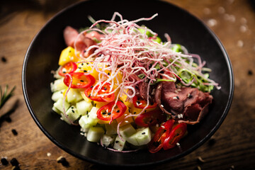 Poke with beef: Glass noodle, avocado, edamame and mango in a bowl. Delicious healthy food closeup served for lunch on a table in modern gourmet cuisine restaurant - 552602505
