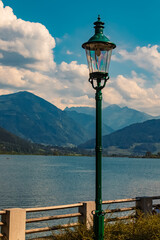 Fototapeta na wymiar Beautiful alpine summer view with details of a street lamp at the famous Zeller See lake, Zell am See, Salzburg, Austria