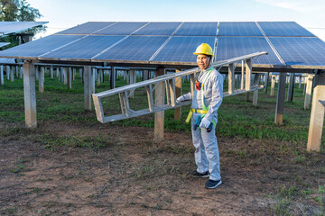 Maintenance engineer on duty cary step ladder stand portrait look camera ready to work at solar farm