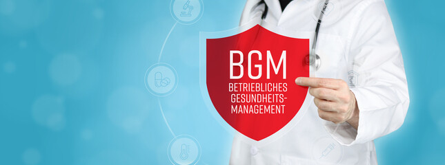 BGM (Betriebliches Gesundheitsmanagement). Arzt hält rotes Schutzschild umgeben von Icons im...