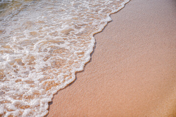 Close-up of white sand, washed by soft sea waves