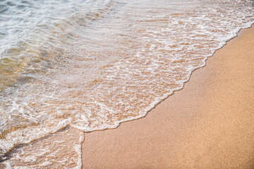 Close-up of white sand, washed by soft sea waves