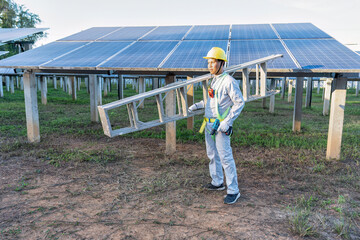 Maintenance engineer on duty cary step ladder stand portrait look camera ready to work at solar farm