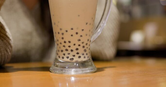 Stir with bubble milk tea in restaurant