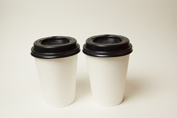two glasses of takeaway coffee on a white background