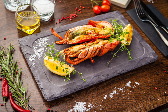 Lobster with flavored butter. Herb butter, lemon. Delicious healthy traditional food closeup served for lunch in modern gourmet cuisine restaurant