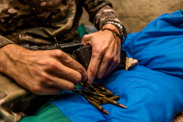 a handful of bullets in the hands of a soldier. bullet shop