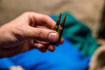 a handful of bullets in the hands of a soldier. bullet shop