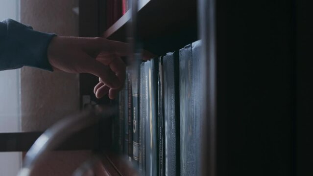 A man choosing a book from a bookshelf