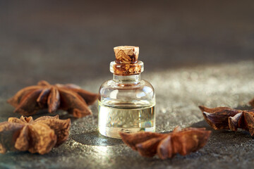 Obraz na płótnie Canvas A bottle of essential oil with dried star anise