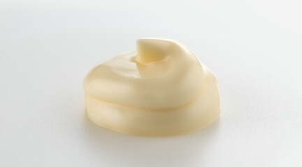 Mayonnaise swirl close up. Handful of home made healthy vegan mayonnaise on white background. White cream, sauce. 