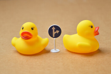 Yellow duck toys heading to different directions.