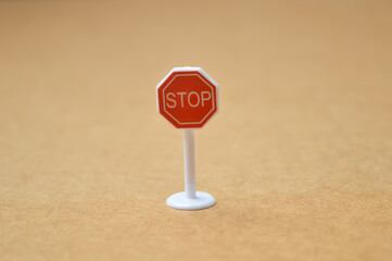 Stop sign symbol used for traffic controlling and road safety with blurred background.