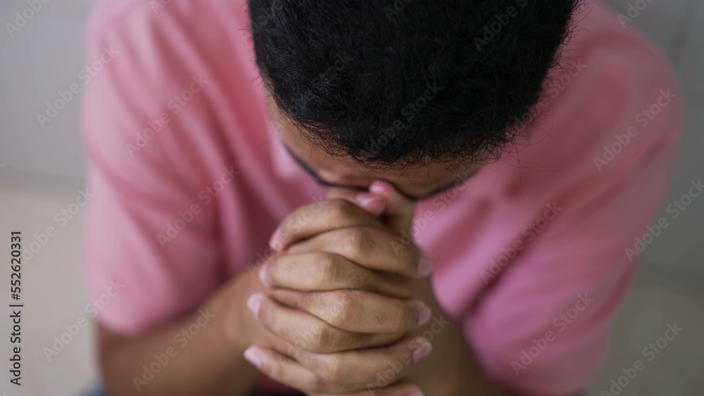 Wall mural hopeful young man in prayer. closeup person hands praying to god. spiritual and religious individual