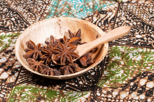 Asterisk on wooden spoon on a batik table cloth.