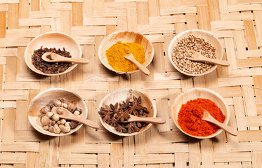 Asian spices, seasonings, and condiment on bamboo.