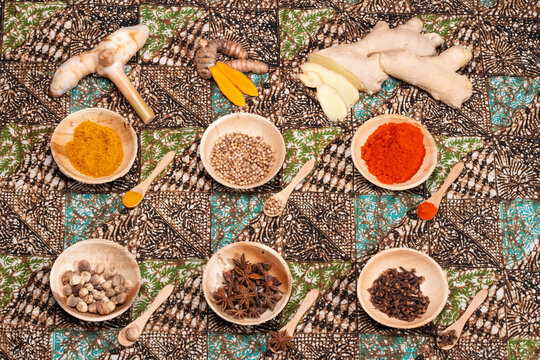 Asian spices, seasonings, and condiment on a table cloth.