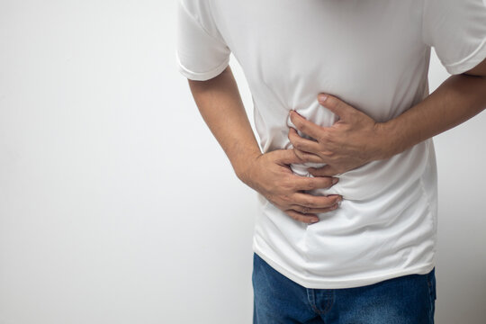 man having abdominal pain on white background