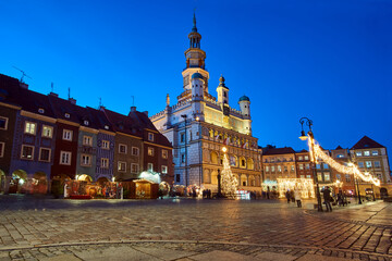 historic tenement houses and the renaissance town hall with Christmas decorations on the market square at night
