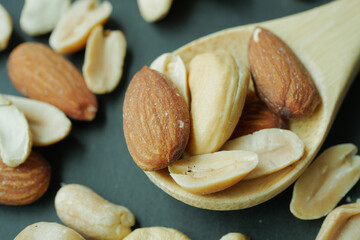 close up of almond nuts on a spoon on table 