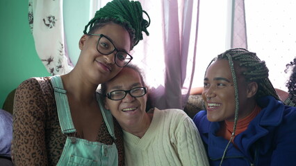 Four happy black hispanic women. Generational joyful latin South American people laughing and...