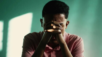 Dramatic South American young man worshipping God. Faithful person asking for God help and support. Hopeful Brazilian guy