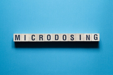 Microdosing - word concept on cubes