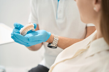 Professional dental hygienist advising client before treatment © Viacheslav Yakobchuk