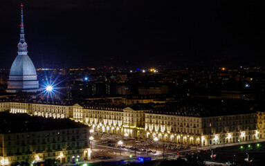 Fototapeta na wymiar View of Turin by night from hill with Mole Antonelliana in background and Piazza Vittorio Veneto, Piazza Castello and the hills