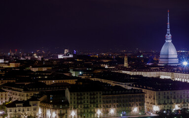 View of Turin by night from hill with Mole Antonelliana in background and Piazza Vittorio Veneto, Piazza Castello and the hills