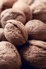 Walnuts with and without shells as background.